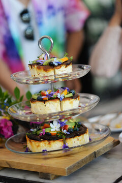 Elegant dinner table setting at a restaurant with plates of gourmet food and appetizers wedding cake 