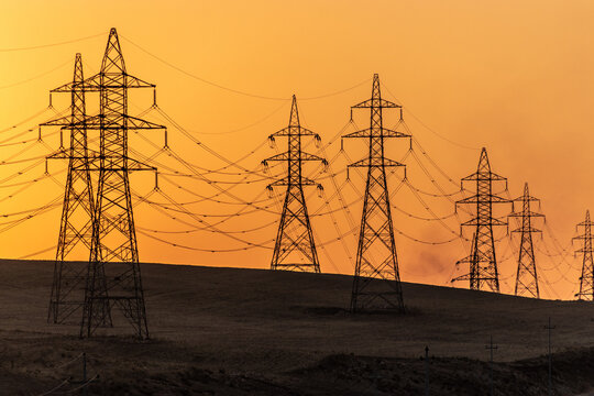 Silhouettes of high voltage electric lines during sunset, Kurdistan Region of Iraq