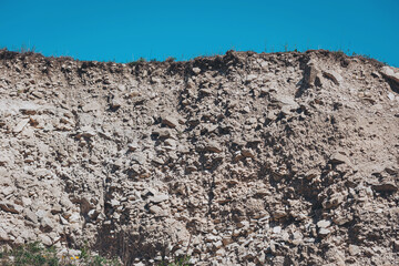 Rocky landscape under a clear blue sky showcasing the natural beauty of erosion and geological formations in a remote area