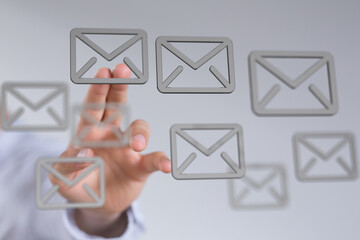 Hand interacting with email icons,concept for email management, inbox, communication.