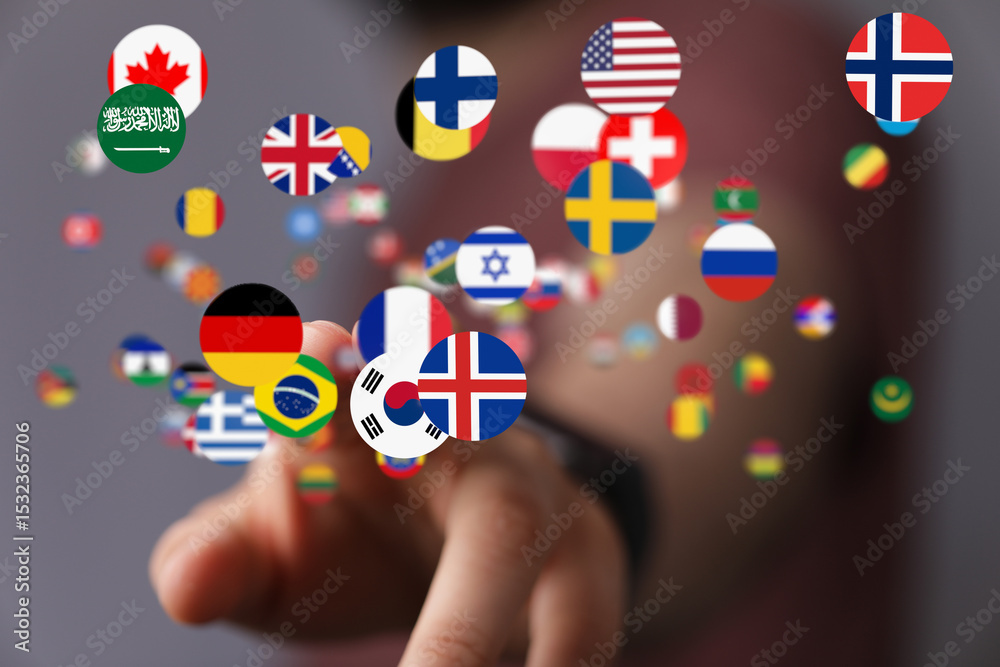Poster Hand interacting with floating flags representing international connection and globalization.