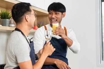 LGBT Couple Enjoying Drinks in Modern Kitchen