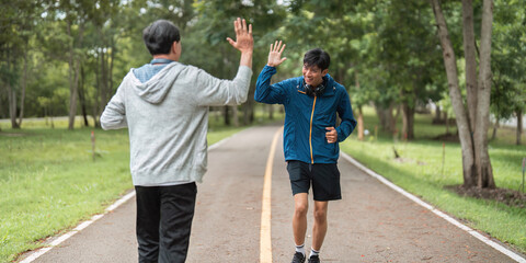 Father and Son Celebrating Fitness with High-Fives Outdoors