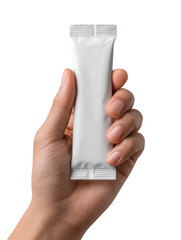 A hand holding a small white rectangular packet against a dark background in a close up shot