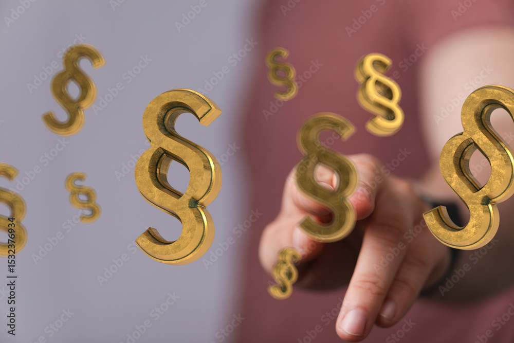 Poster abstract image of golden paragraph symbols floating near a hand, representing legal concepts.