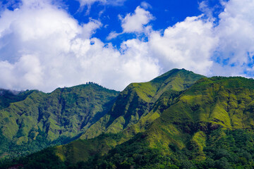 A view of the green landscape of the Rinjani volcano in summer. Farmland view from Selong Hill, Sembalun, Lombok, West Nusa Tenggara, Indonesia.