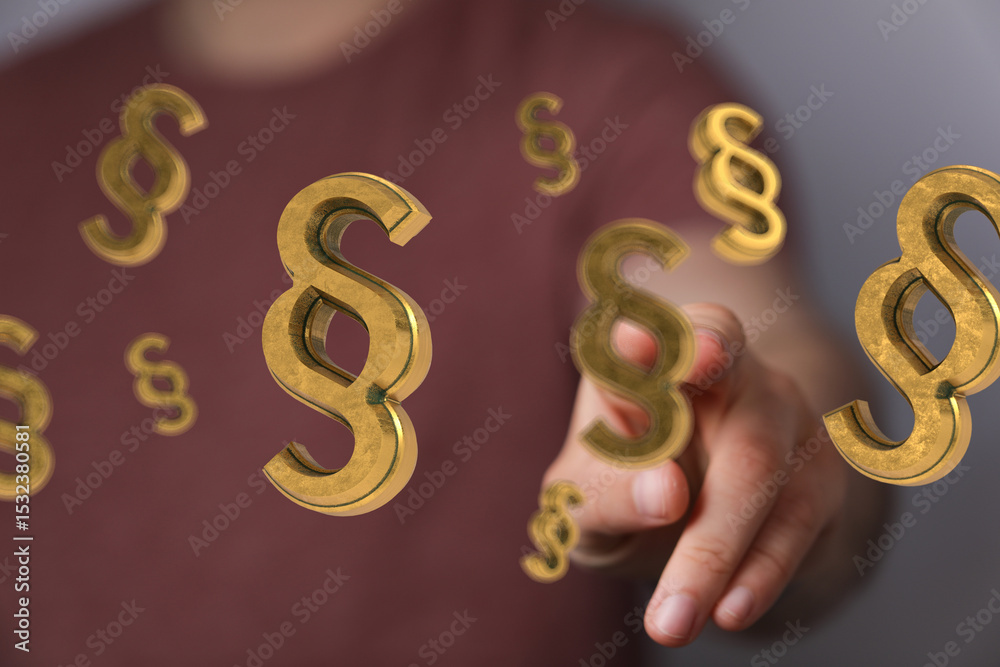 Poster abstract image of golden paragraph symbols hovering near a hand, representing legal concepts.