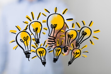 Image of multiple hand-drawn lightbulbs, symbolizing innovation and creativity.