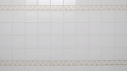 White ceramic wall tiles with geometric orange triangle pattern in minimalist bathroom or kitchen interior