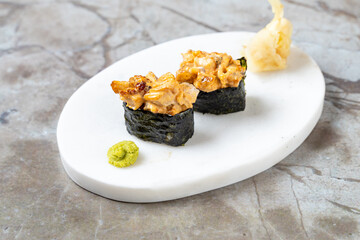 Intricately crafted sushi showcases tender seafood enveloped in seasoned rice and nori. Accompanied...