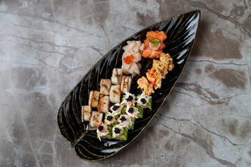 Delve into the art of sushi with a beautifully arranged platter featuring an array of fresh seafood, offering a vivid display of color and taste in a chic dining atmosphere