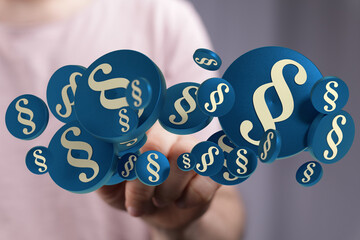 Image of paragraph symbols floating in hands, ideal for legal, law, and justice related concepts.