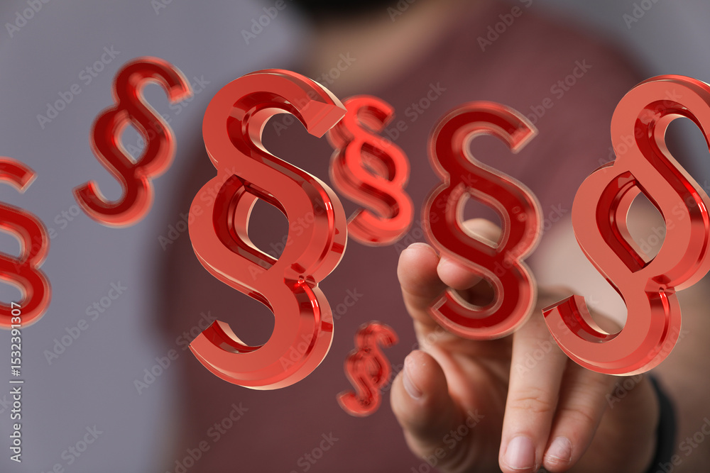 Poster abstract image of red paragraph symbols floating around a hand, ideal for legal or law concepts.