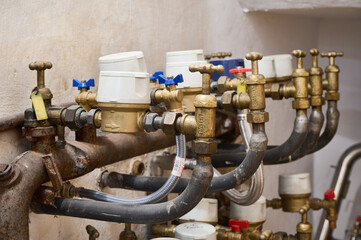 Close up of water meters and valves regulating water flow in a residential building, ensuring...