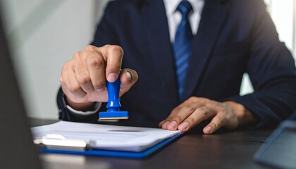 Hand man stamping documents notary public in office. Businessperson stamping approval of work finance banking or investment marketing documents on desk.
