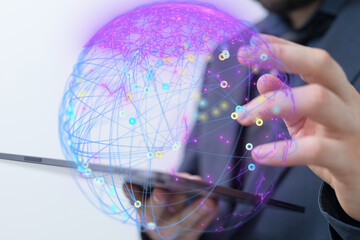 Person using a tablet to interact with a global network visualization.  Digital technology,...