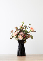 summer flowers in black vase on white background