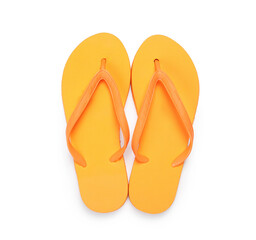 Stylish orange flip flops isolated on white, top view. Beach accessory