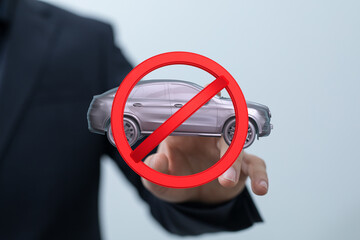 Image of a hand holding a no car allowed sign. Perfect for illustrating driving bans, parking...