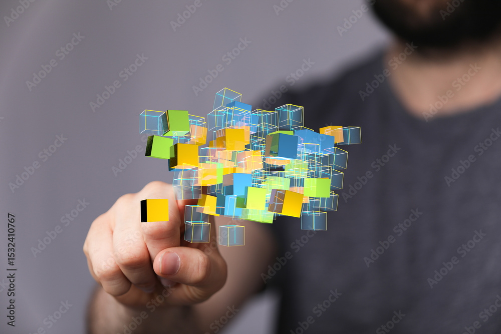 Leinwandbilder Man interacts with a digital cluster of colorful data cubes, representing complex information processing.