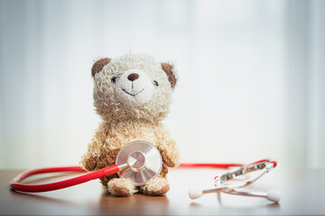 Teddy bear with stethoscope. Symbol of pediatric care, warmth, child healthcare, compassion, and...