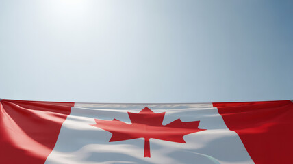 the Canadian flag proudly displayed against a clear, expansive blue sky, offering ample copy space for text or additional design elements