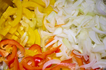 Mixed chopped vegetables for cooking, onion, yellow and red bell pepper, carrot