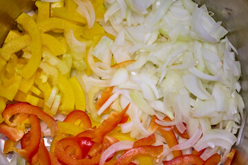 Mixed chopped vegetables for cooking, onion, yellow and red bell pepper, carrot