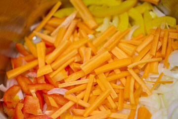 Mixed chopped vegetables for cooking, onion, yellow and red bell pepper, carrot
