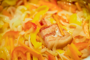 mixed vegetables with bacon in a wok put to cook