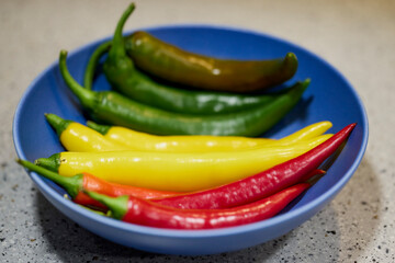 mixed chili peppers in three colors on a table