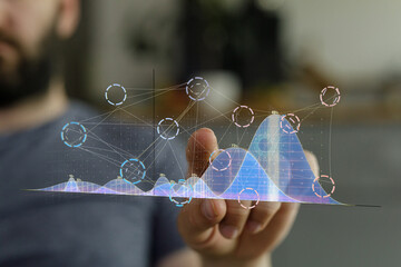 Stock photo of a man interacting with a digital graph, visualizing data analysis and business...
