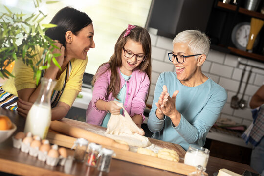 Happy loving family are preparing bakery together.