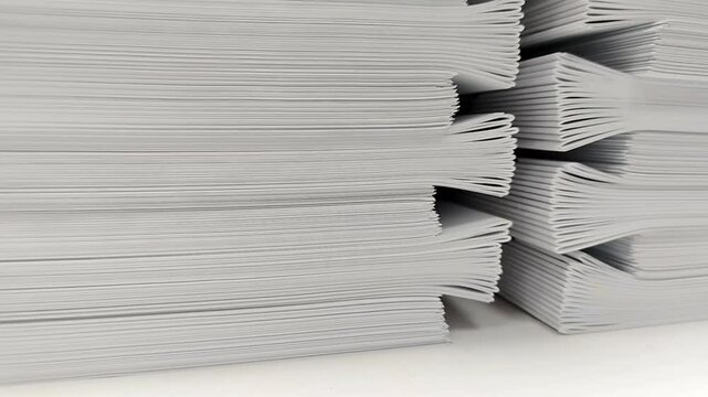 Close-up of a stack of glued book blocks prepared for binding in a printing house, selective focus