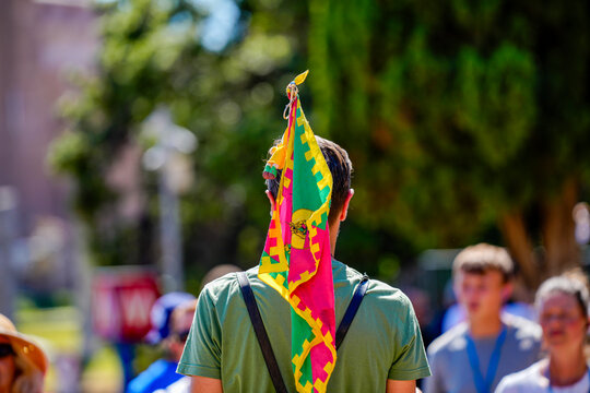 Scout leader wearing grenada flag on his head during a gathering
