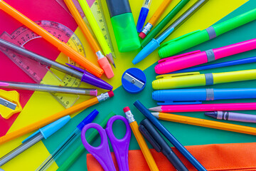 Multicolored background with stationery, objects for painting and school, scissors, pens,...