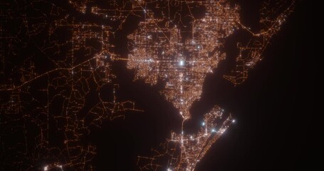 Panama City (Florida, USA) top view at night. Aerial view on modern city with lights. Camera is flying above the city, moving backward. Vertical video. The north is on the left side - Powered by Adobe