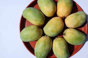 Top view of delicious Alphonso Mango fruits arrange on plate, King of fruiAts Mango Kesar keri variety