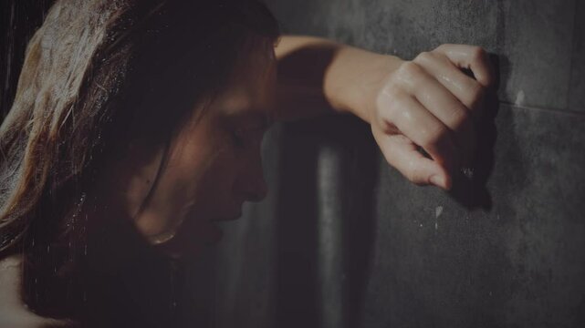 Natural beauty woman crying standing under the shower drops of water flowing down the face wet hair, mood depression sadness loneliness emotion. Adult Girl sad tear-stained face eyes closed. video 4k.