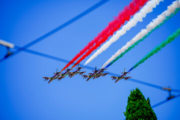 Aerobatic team flying in formation leaving colorful smoke trails