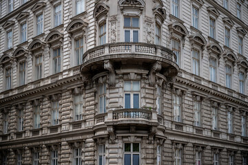 Ornate historic European building with detailed stonework and corner balcony view