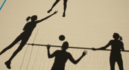Four silhouettes playing volleyball on sandy court in daylight  