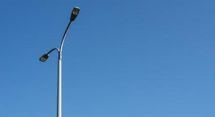 Street lamp against clear blue sky during daytime  