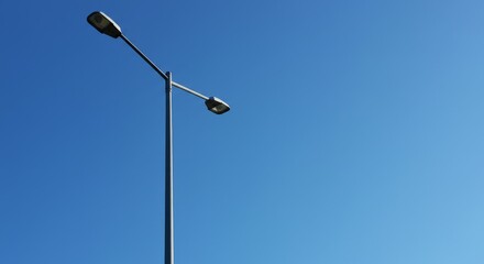 Streetlight against a clear blue sky on a sunny day  
