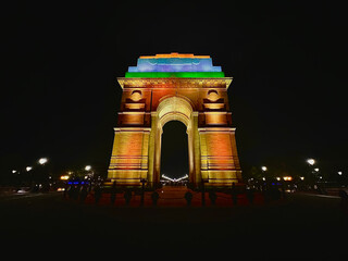 india gate illuminated at night with tricolor lighting showing national pride and architectural elegance of the iconic historic monument in new delhi india