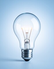 Brightly glowing traditional incandescent light bulb isolated on a soft, radiant gradient background, symbolizing brilliant ideas, innovation, and classic illumination