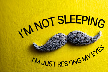  humorous Father's Day design featuring a textured mustache and bold black typography on a bright yellow background with the quote "I’m not sleeping, I’m just resting my eyes."