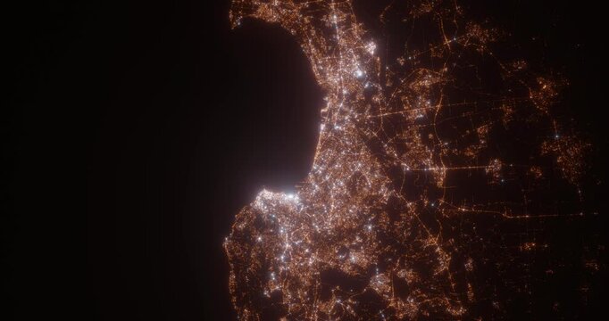 Algiers (Algeria) top view at night. Aerial view on modern city with lights. Camera is flying above the city, moving backward. Vertical video. The north is on the left side