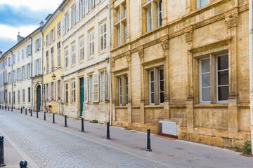 Naklejka premium Cobblestoned street with old houses in Nancy, France