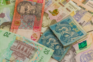 Ukrainian currency gathered on a textured surface